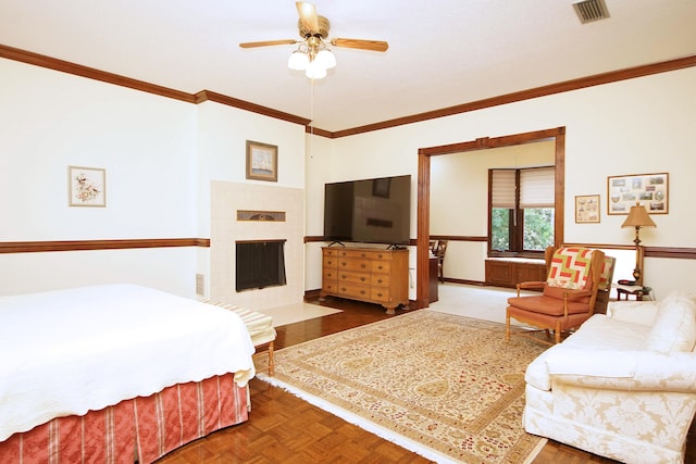 bedroom with ceiling fan, a fireplace with flush hearth, visible vents, and crown molding