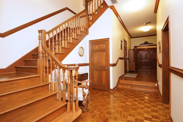 stairs featuring ornamental molding and baseboards