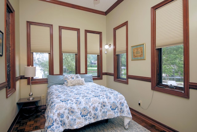 bedroom with ornamental molding, baseboards, and a ceiling fan