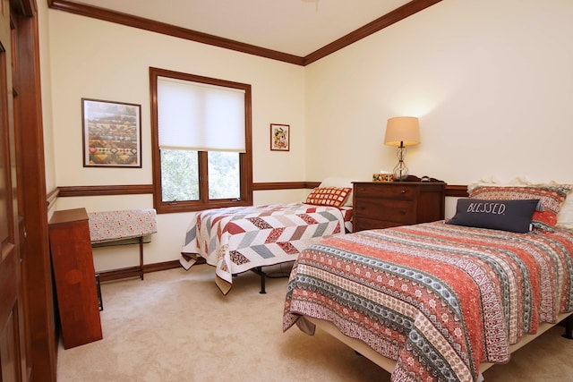 bedroom featuring carpet, baseboards, and crown molding