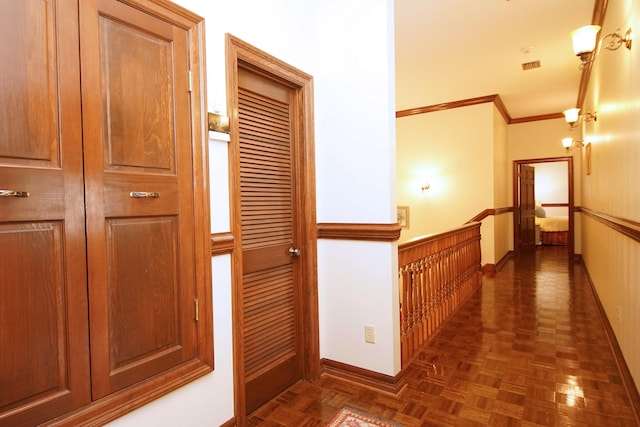 hall featuring baseboards, crown molding, and wainscoting