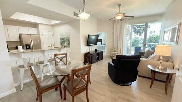 dining room with ceiling fan and light hardwood / wood-style floors