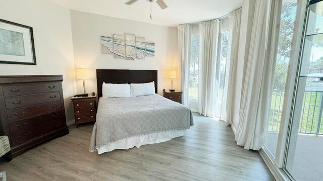 bedroom with hardwood / wood-style flooring, ceiling fan, and access to exterior