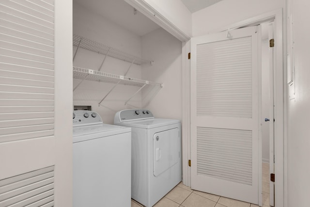 laundry room with washer and dryer, light tile floors, and hookup for a washing machine