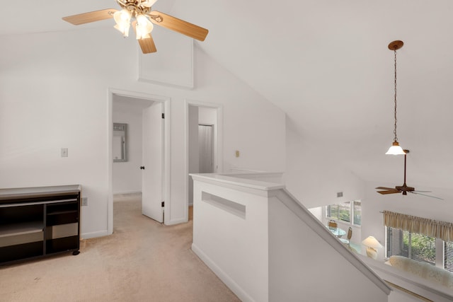 corridor featuring high vaulted ceiling and light colored carpet