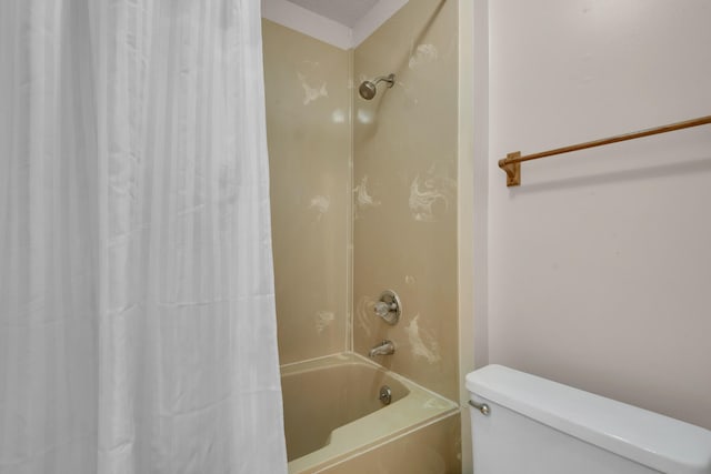 bathroom with a textured ceiling, toilet, and shower / bath combo with shower curtain