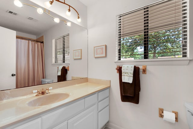 bathroom featuring large vanity and toilet