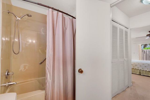 bathroom with toilet and shower / bath combo with shower curtain