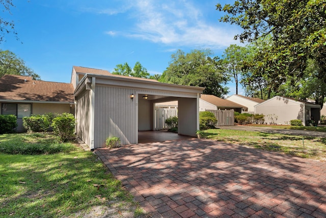 back of property featuring a yard and a carport