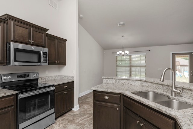 kitchen with appliances with stainless steel finishes, dark brown cabinetry, vaulted ceiling, sink, and a chandelier