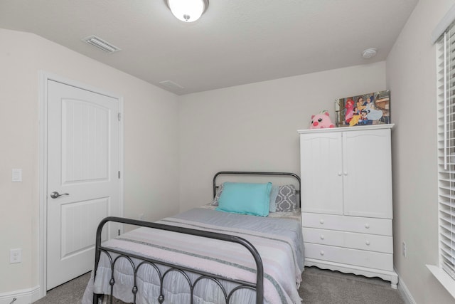 bedroom with carpet floors and a textured ceiling