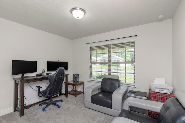 carpeted office space featuring a textured ceiling