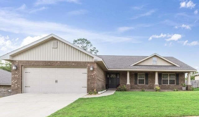 view of front of home featuring a garage and a front lawn