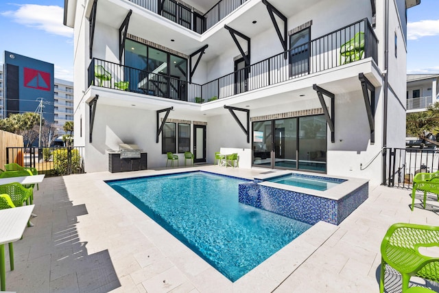 view of swimming pool featuring a patio area and an in ground hot tub