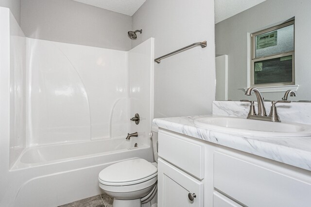 full bathroom with vanity, a textured ceiling, shower / bathing tub combination, and toilet