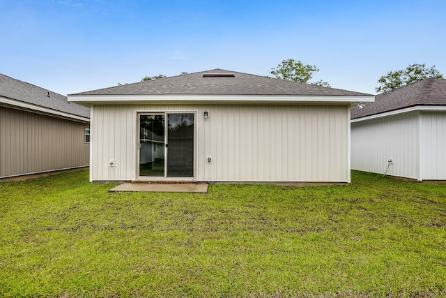 back of property featuring a yard