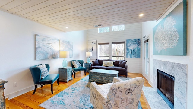 living room featuring light hardwood / wood-style flooring and a fireplace