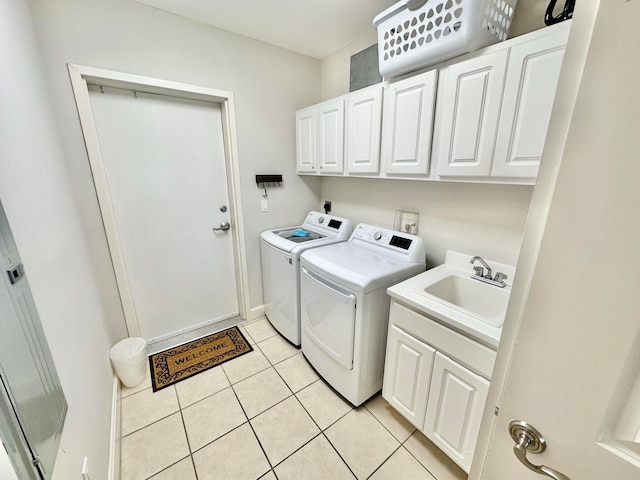 laundry room featuring cabinets, separate washer and dryer, light tile patterned floors, and sink