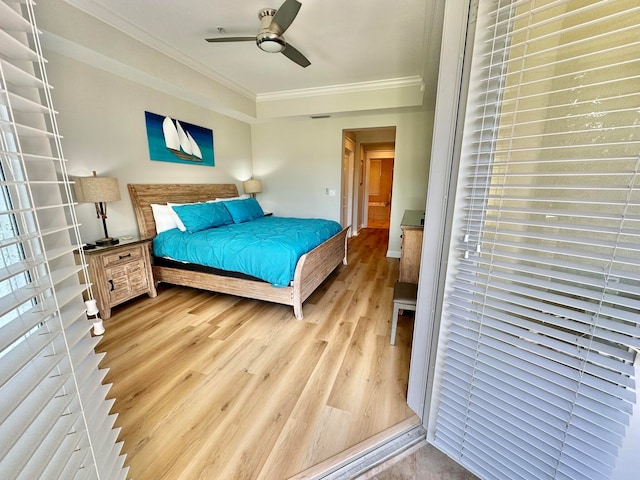 bedroom featuring ceiling fan, ornamental molding, and wood-type flooring