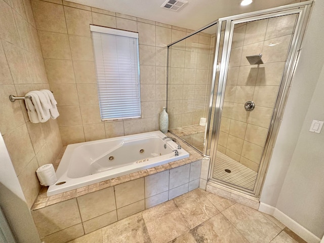 bathroom featuring shower with separate bathtub