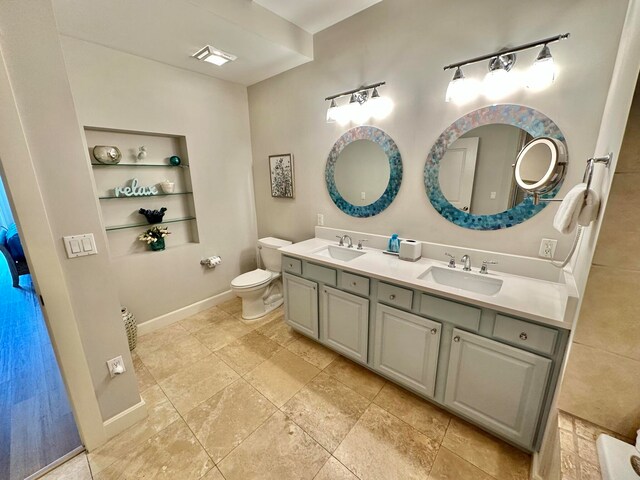 bathroom with toilet and vanity