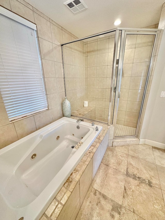 bathroom featuring independent shower and bath