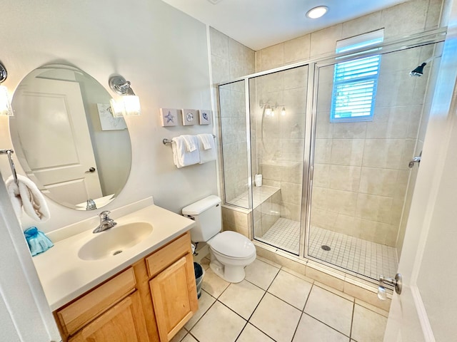 bathroom featuring tile patterned flooring, an enclosed shower, vanity, and toilet