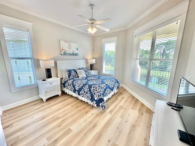 bedroom featuring ceiling fan, light hardwood / wood-style flooring, and ornamental molding