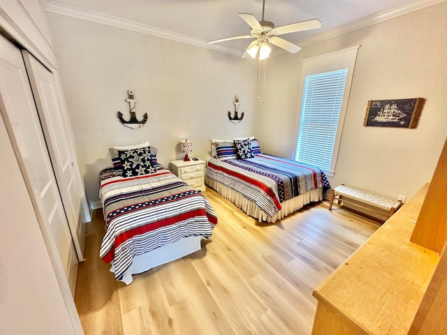 bedroom featuring hardwood / wood-style floors, ceiling fan, a closet, and ornamental molding