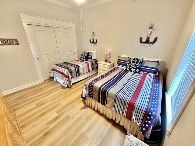 bedroom featuring a closet, hardwood / wood-style flooring, and ornamental molding