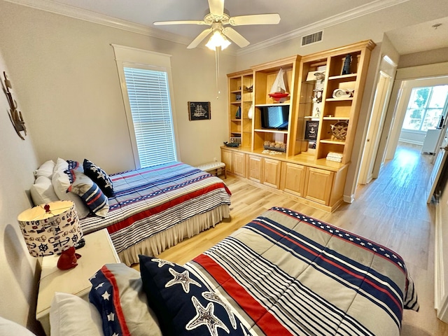 bedroom featuring ornamental molding, ceiling fan, and light hardwood / wood-style flooring