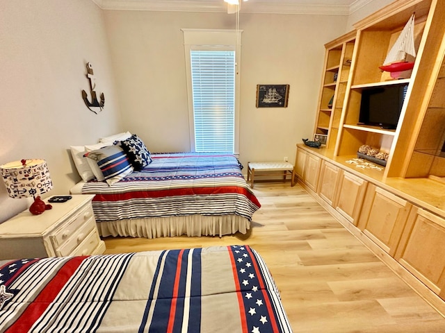 bedroom featuring light wood-type flooring and ornamental molding