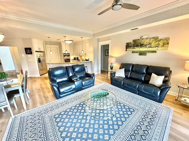 living room featuring ceiling fan, light hardwood / wood-style flooring, and crown molding