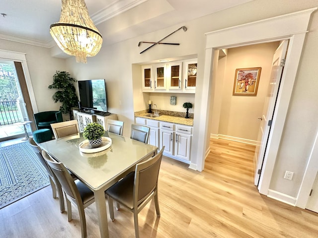 5377 Pine Ridge Ln Unit 5377, Miramar Beach, FL 32550 - dining area with light wood finished floors, ornamental molding, a chandelier, and baseboards
