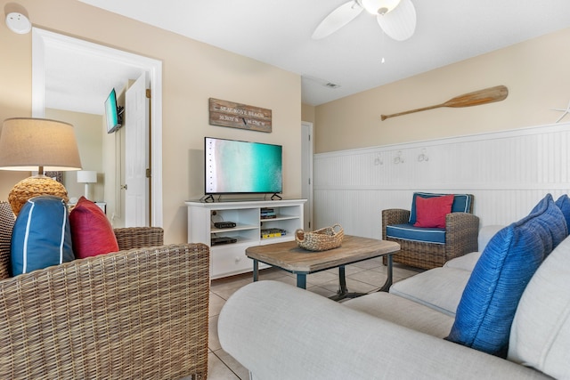 living room featuring ceiling fan and tile floors