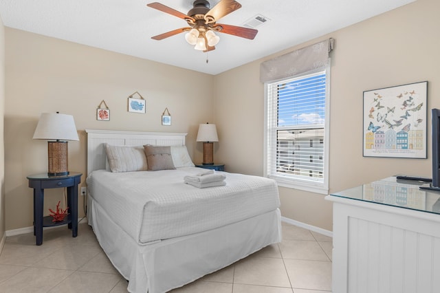 bedroom featuring ceiling fan and light tile floors