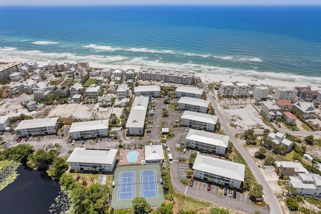 drone / aerial view with a beach view and a water view