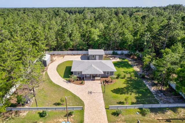 521 W Juniper Ave, Defuniak Springs, FL 32433 - aerial view of property and surrounding area featuring a heavily wooded area