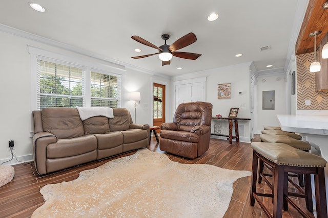 living room featuring dark hardwood / wood-style floors, ceiling fan, ornamental molding, and electric panel