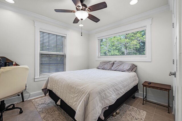 tiled bedroom with ceiling fan and crown molding