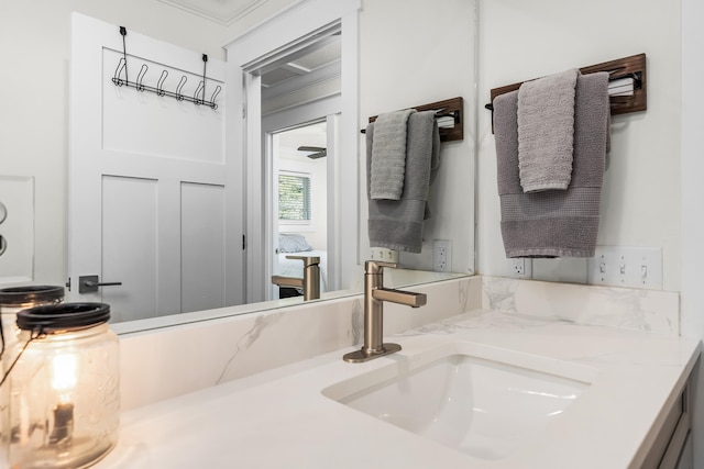 bathroom featuring crown molding and vanity