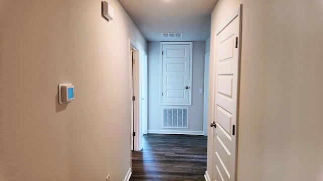 hallway with dark hardwood / wood-style flooring