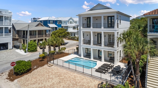 view of swimming pool featuring a patio and an in ground hot tub