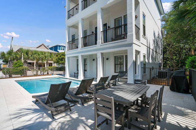 view of swimming pool with a patio area and central air condition unit