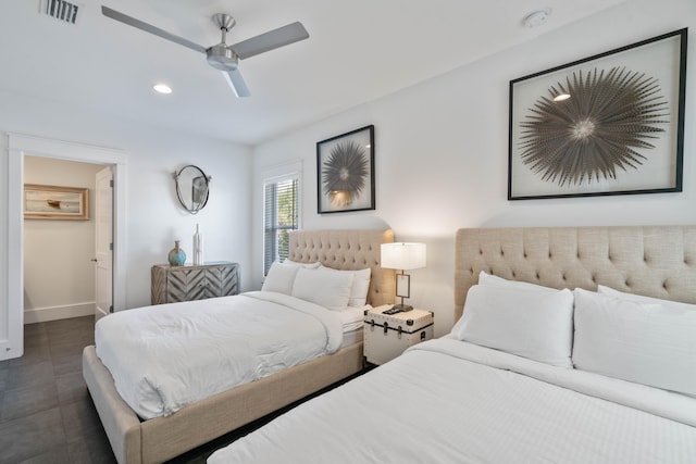 bedroom with dark tile flooring and ceiling fan