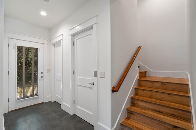 stairway with dark tile floors