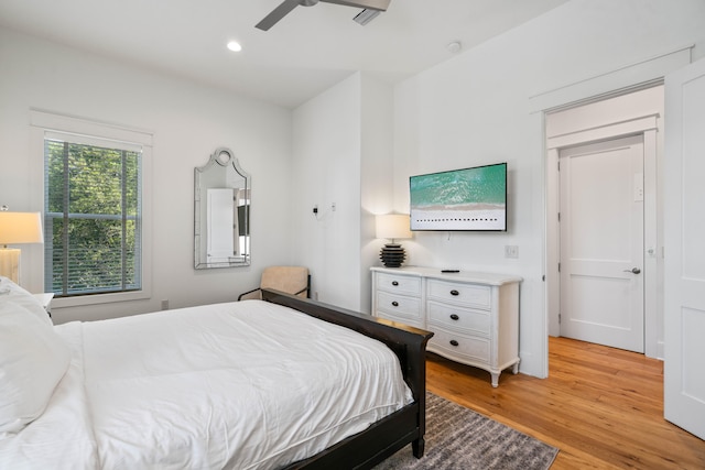 bedroom featuring ceiling fan and light hardwood / wood-style flooring