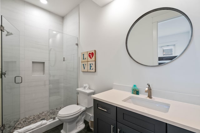 bathroom with a shower with door, toilet, and vanity