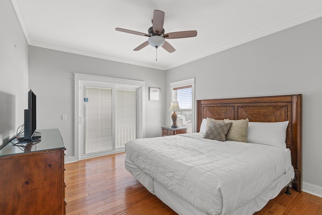 bedroom featuring ceiling fan, light hardwood / wood-style floors, and crown molding