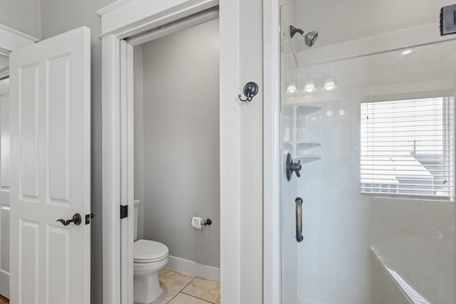 bathroom featuring tile floors and toilet